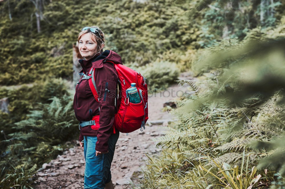 Similar – Woman doing trekking looking at camera