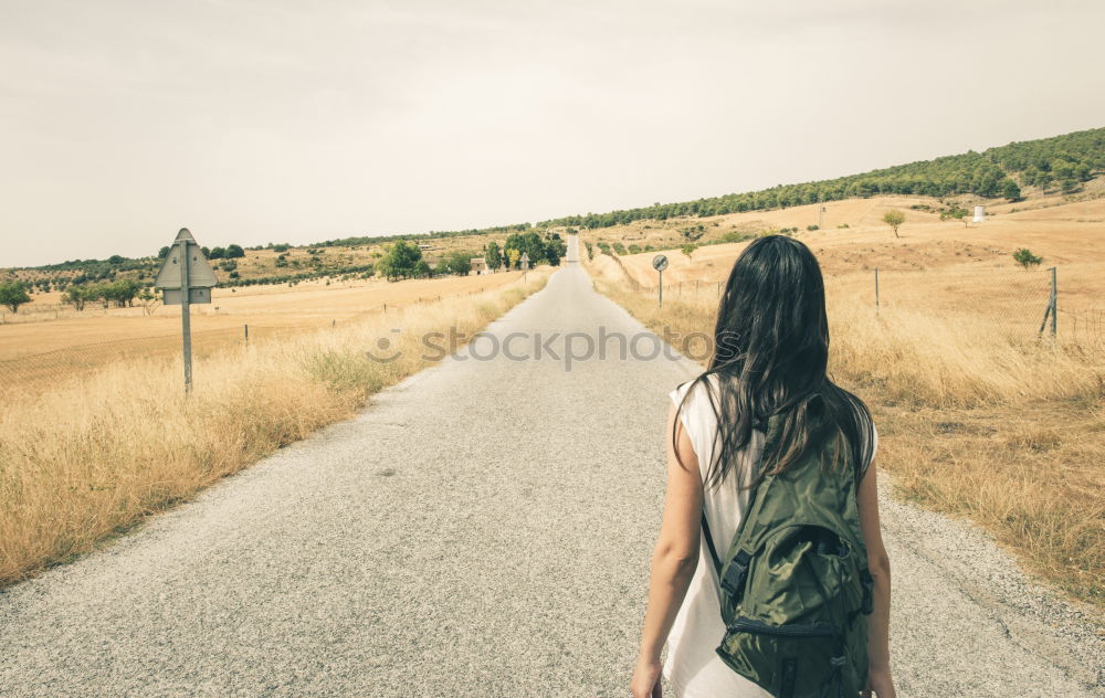 Image, Stock Photo Woman with backpack walking on the road