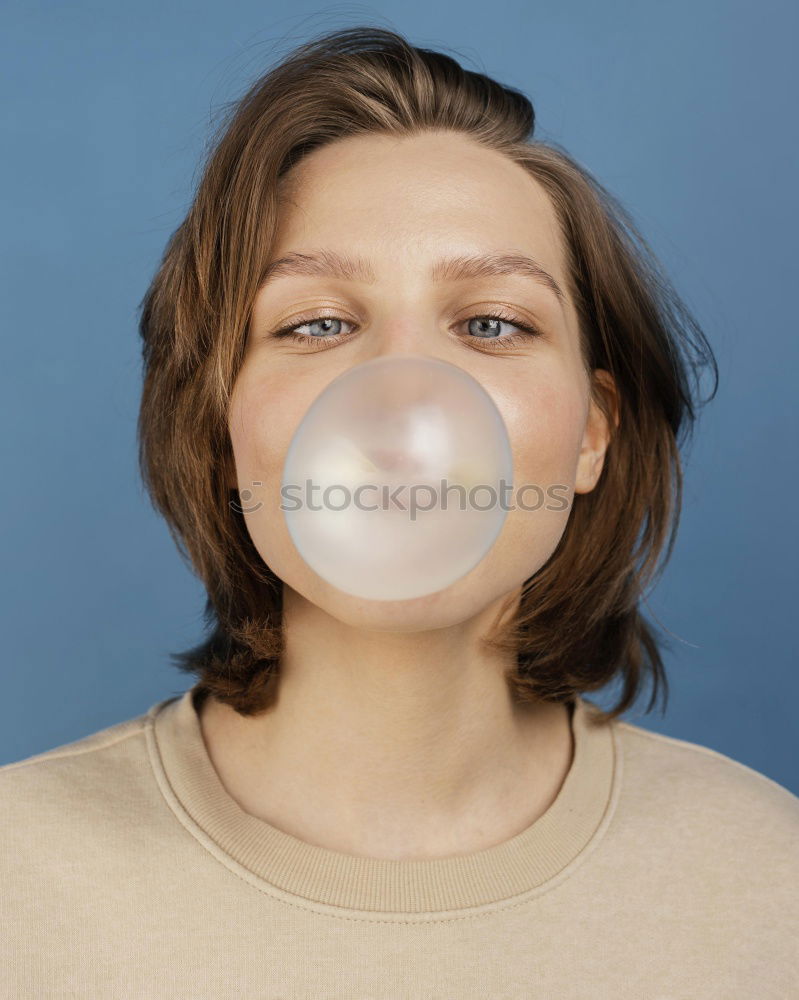 Similar – Image, Stock Photo Young blonde woman making a chewing gum bubble