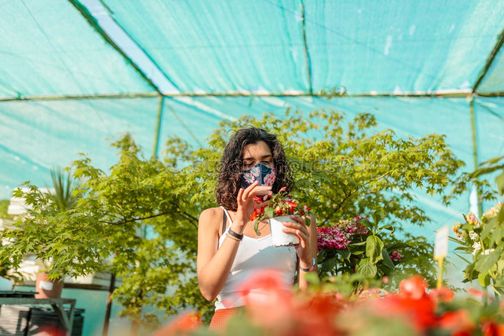 Similar – Portrait of smiling young african woman in greenhouse