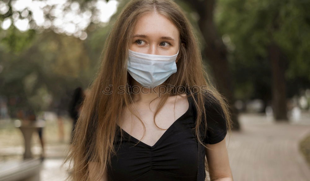 Similar – Young woman in medical mask standing near blooming flowers