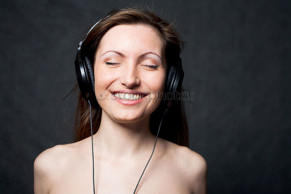 Similar – Two happy teenage girls lying on the grass sharing headphones to listen to music