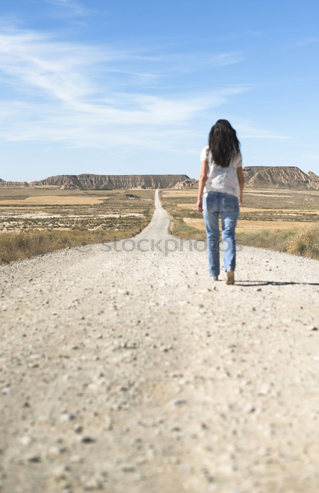 Image, Stock Photo Woman with jeans walking on wild west