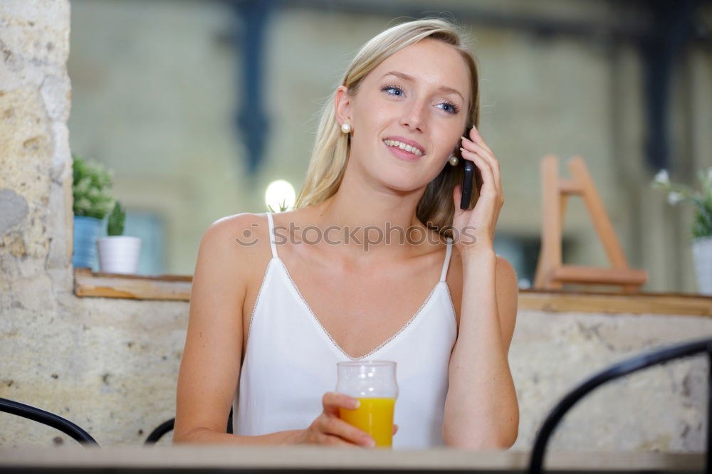 Similar – Image, Stock Photo Smiling young woman sitting at table in cafe