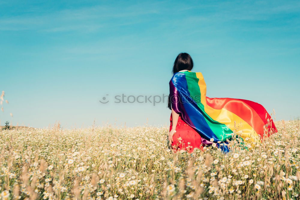 Similar – Image, Stock Photo Woman holding the Gay Rainbow Flag on green meadow outdoor