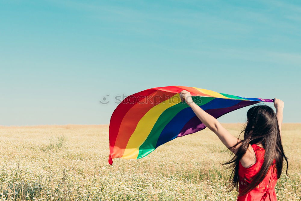 Image, Stock Photo Woman holding the Gay Rainbow Flag on green meadow outdoor