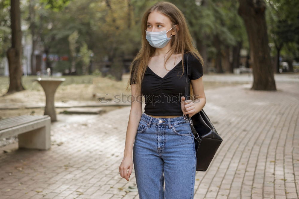 Similar – Young woman in medical mask standing near blooming flowers