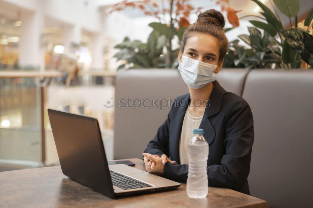 Similar – Young Businessman Wearing Mask Working On Laptop At Hot Desk In Office During Health Pandemic