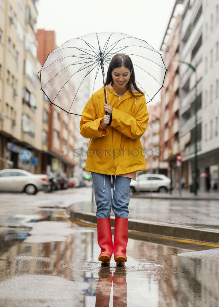 Image, Stock Photo Little girl holding big umbrella walking in a downtown on rainy gloomy autumn day
