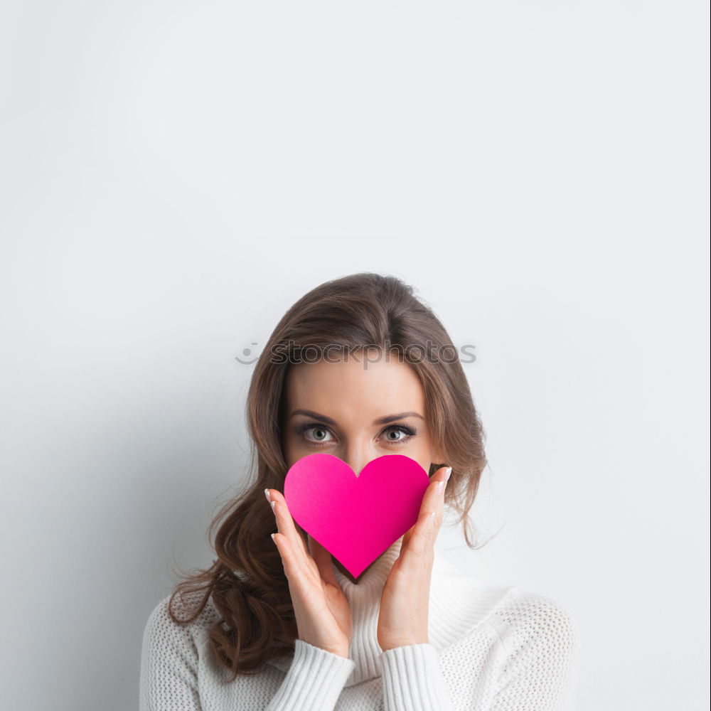 Similar – Image, Stock Photo Beautiful young woman holding a red heart