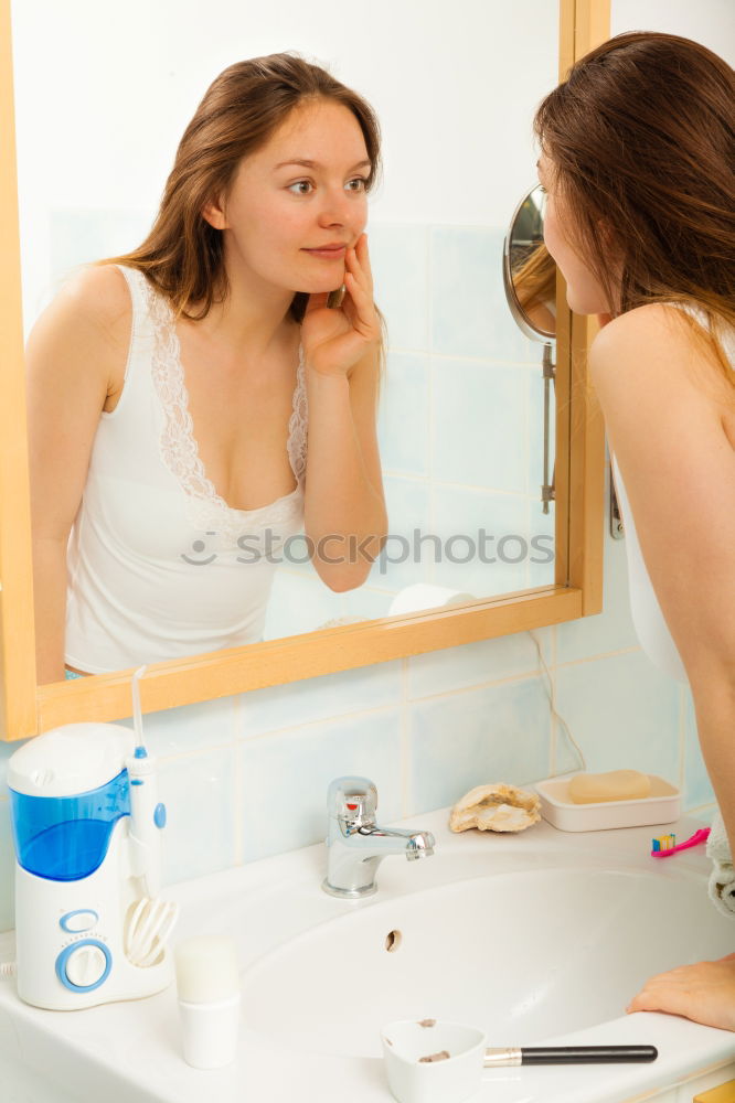 Similar – Young female adult brushing teeth in the morning