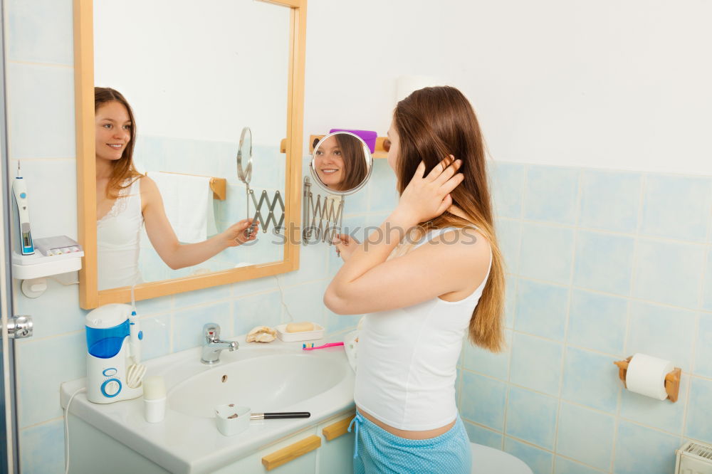 Similar – Young female adult brushing teeth in the morning