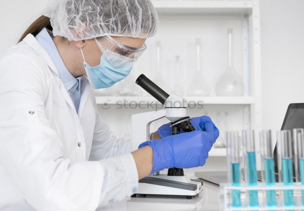 Similar – Worker putting liquid to test tube