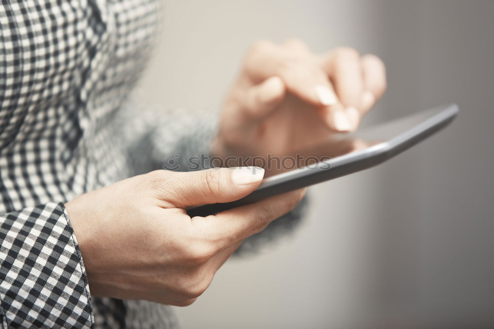 Similar – Woman hands using smartphone and writing notebook