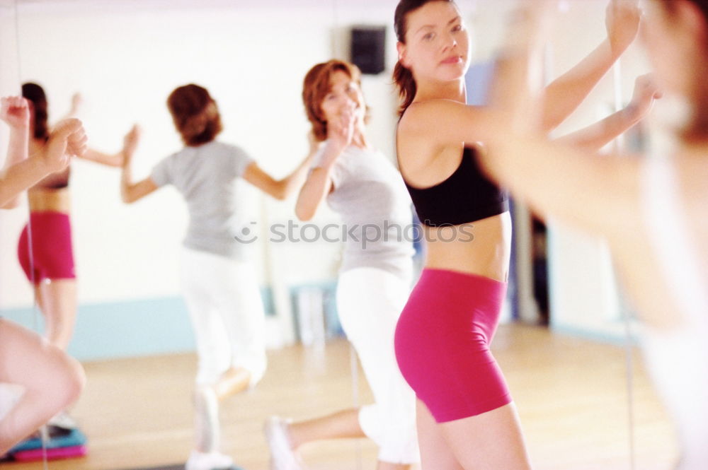 Similar – Group of young sporty attractive women in yoga studio, practicing yoga lesson with instructor, standing, stretching and relaxing after workout . Healthy active lifestyle, working out indoors in gym