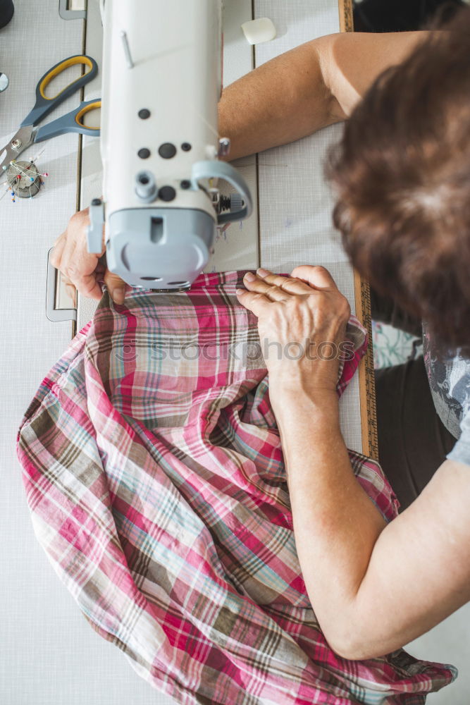 Women sew on sewing machine