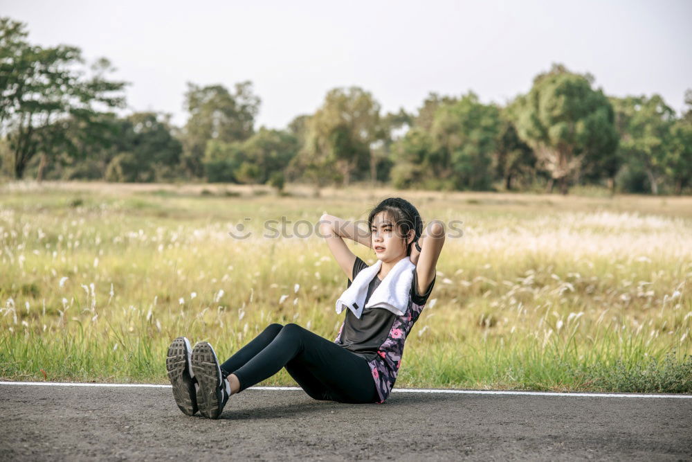 Similar – two women friends sitting down at stairs outdoors using laptop