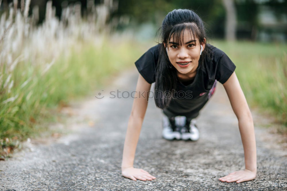 Similar – Athletic young woman doing push up exercises