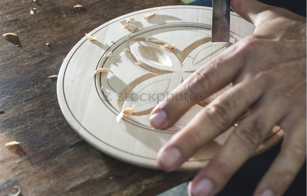 Similar – Hands of woodcarver make wooden bowl