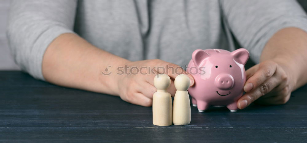 Similar – Thoughtful confused black woman with piggy bank