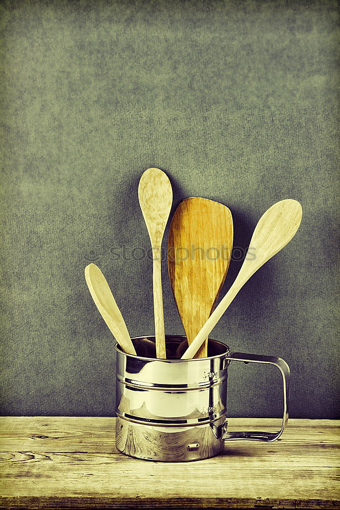 Black cast-iron frying pan with a wooden spatula