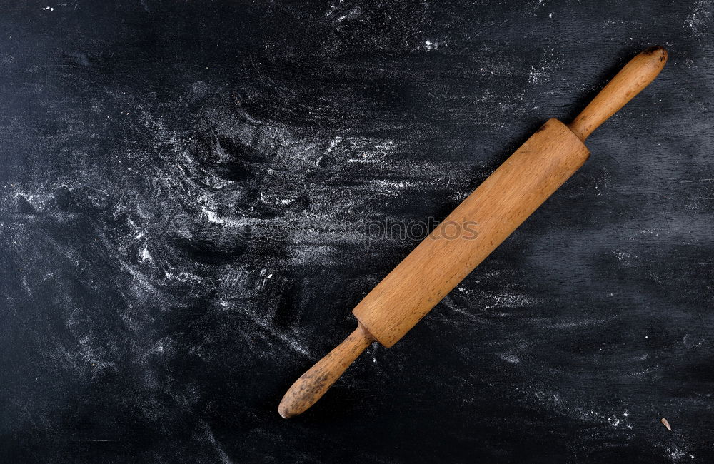 wooden rolling pin and iron bakeware