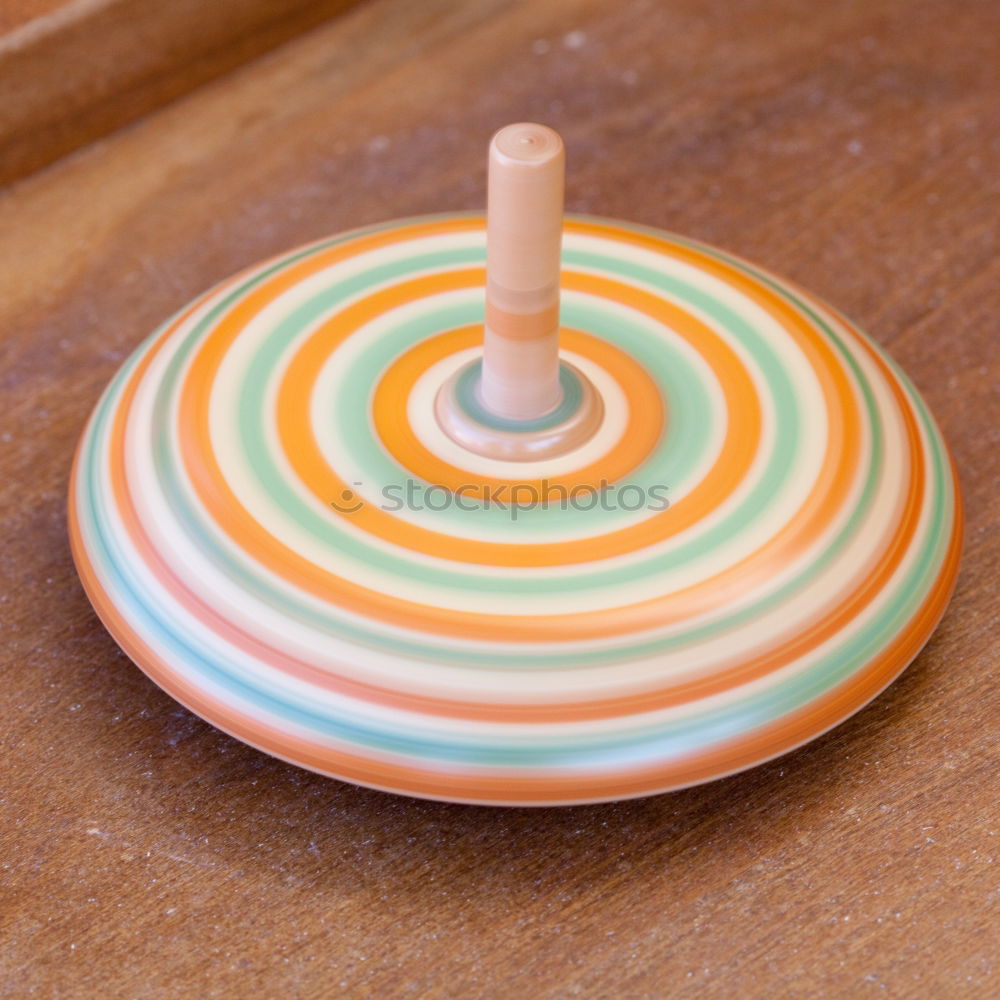 Similar – Image, Stock Photo To the point! A plate with a blue rim, on it many green and a blue ball, dots and a fork on a wooden table