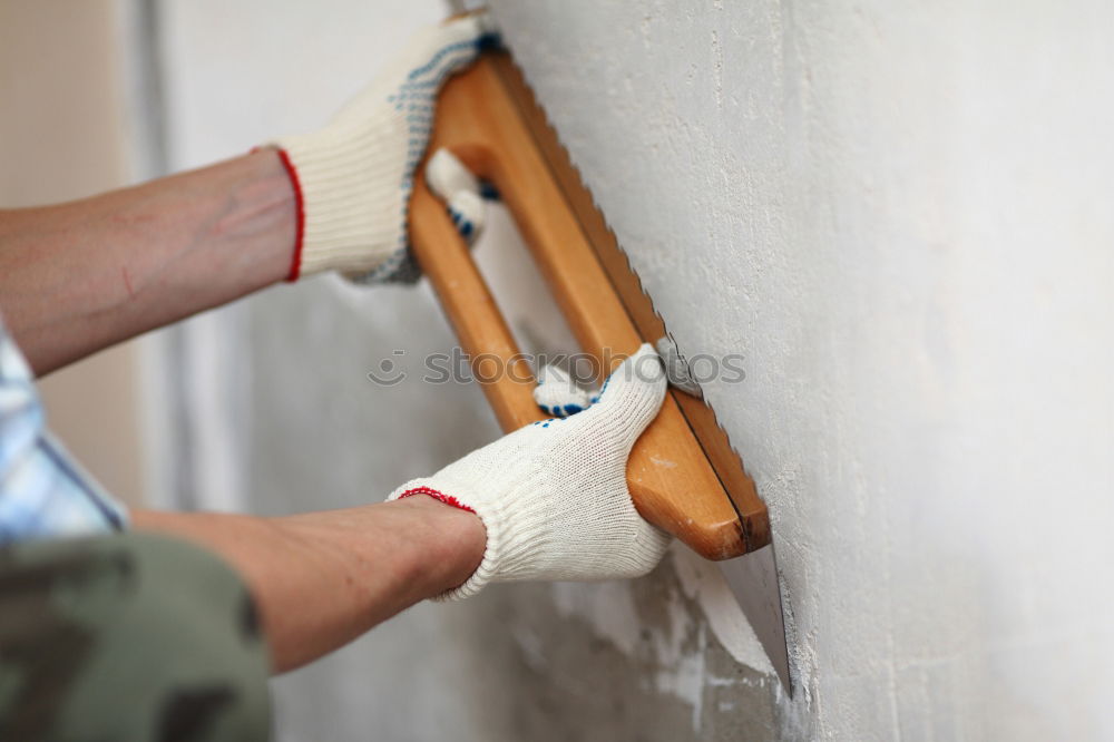 Similar – Mann mit Abbruchhammer entfernt Stuck von der Wand. Konzept der Renovierung