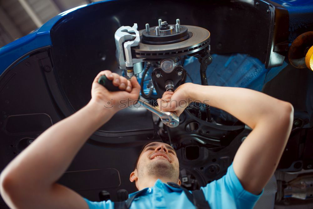 Similar – Image, Stock Photo Professional Mechanic Repairing Car.