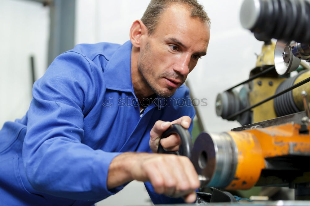 Similar – Professional Mechanic Repairing Car.