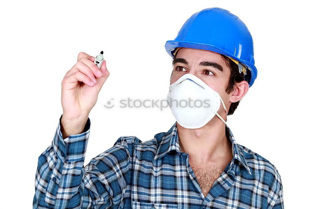 Workman in protective mask and glasses standing on street