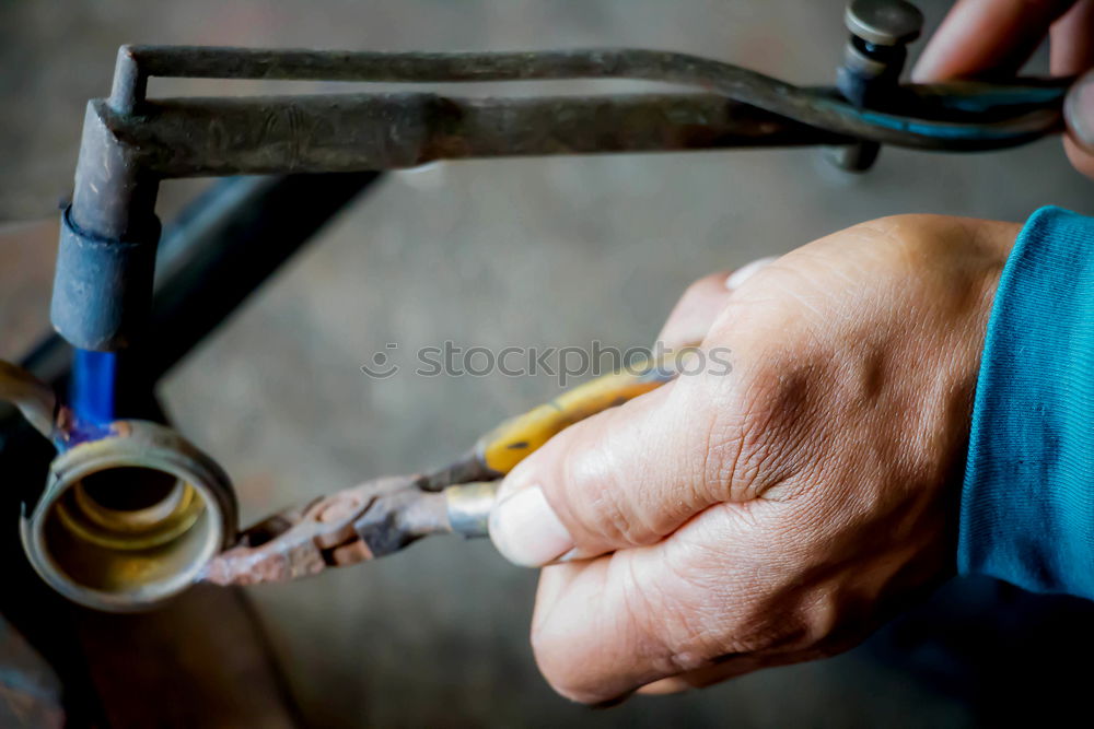 Similar – man’s hands goldsmith work on a piece of silver