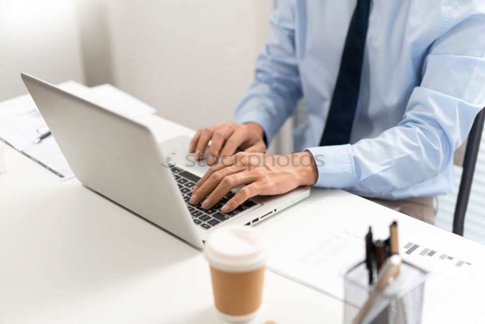 Similar – Young man works on a laptop in the start-up and listens to music through in-ear headphones