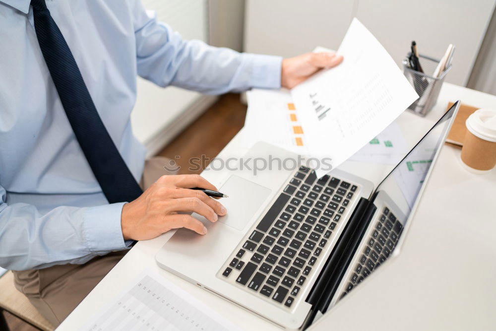 Similar – Young man works on a laptop in the start-up and listens to music through in-ear headphones