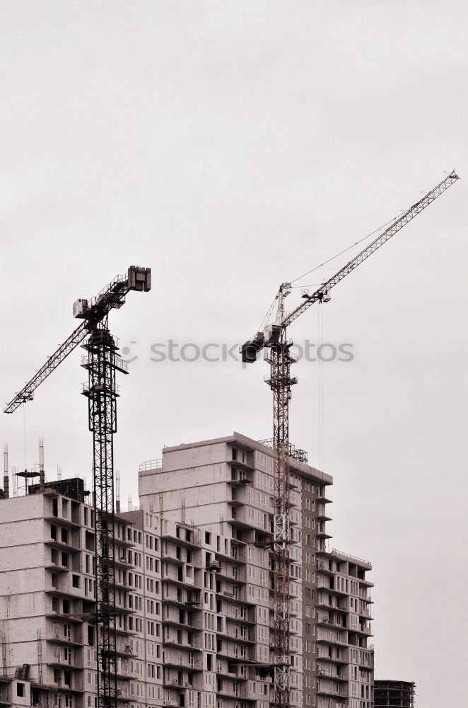 Similar – Construction site with building cranes