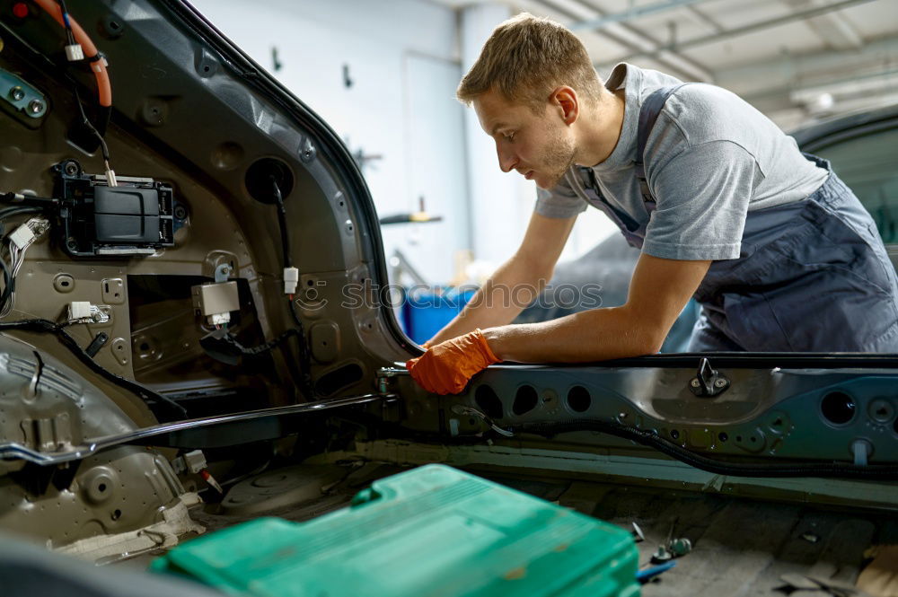 Similar – Professional Mechanic Repairing Car.