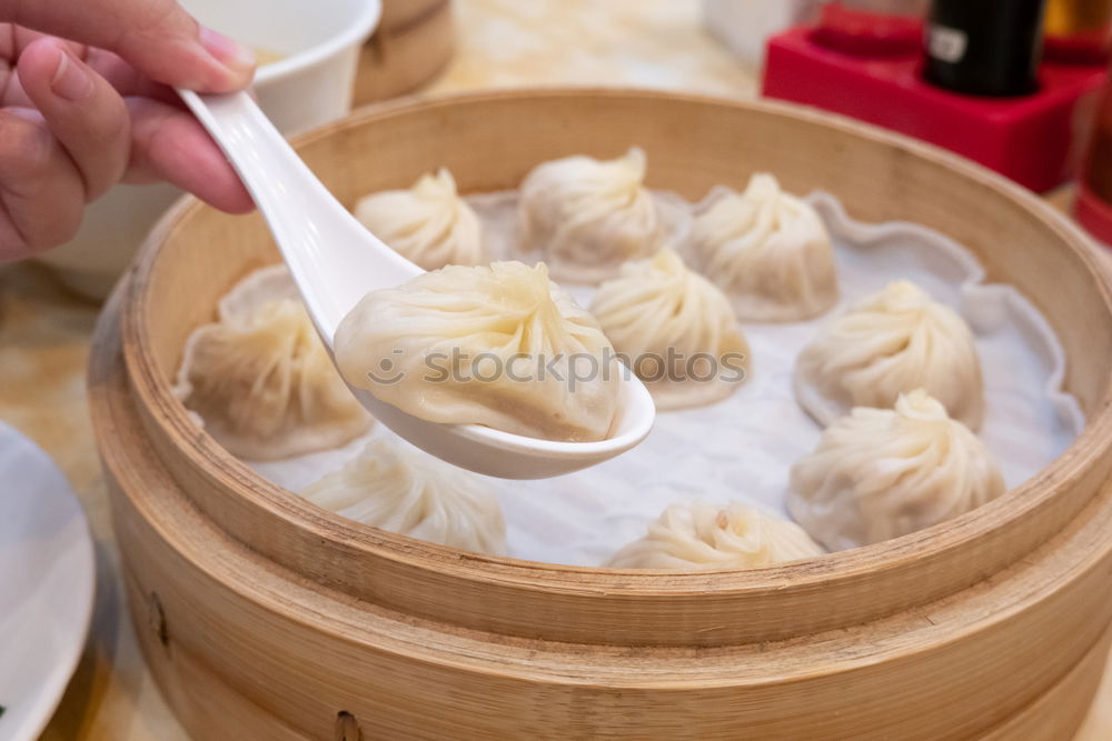 Similar – Dumplings or gyoza served in traditional steamer