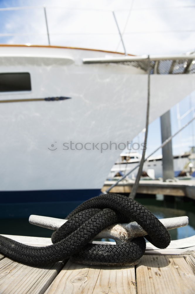 Similar – Fenders suspended between a boat and dockside for protection. Maritime fenders