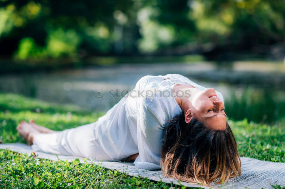 Similar – Young woman doing yoga in nature.