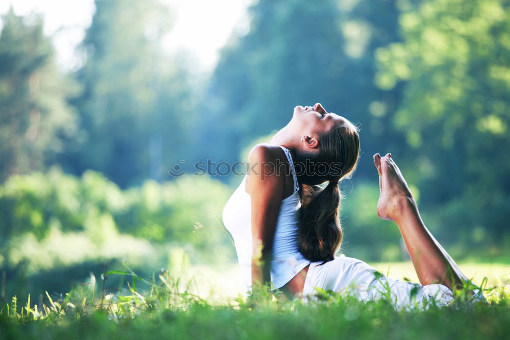 Image, Stock Photo Mother and daughter doing yoga exercises on grass in the park at the day time