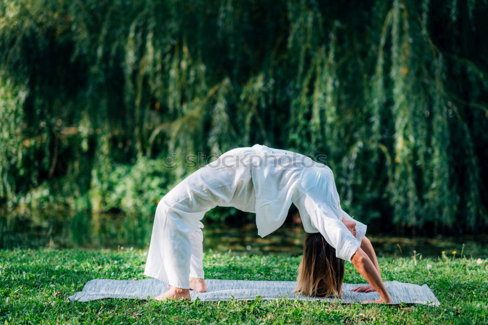 Similar – Young woman doing yoga in nature.