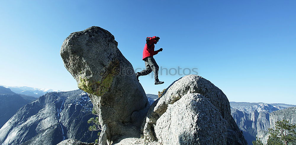 Similar – Rock climbing team reaching the summit.