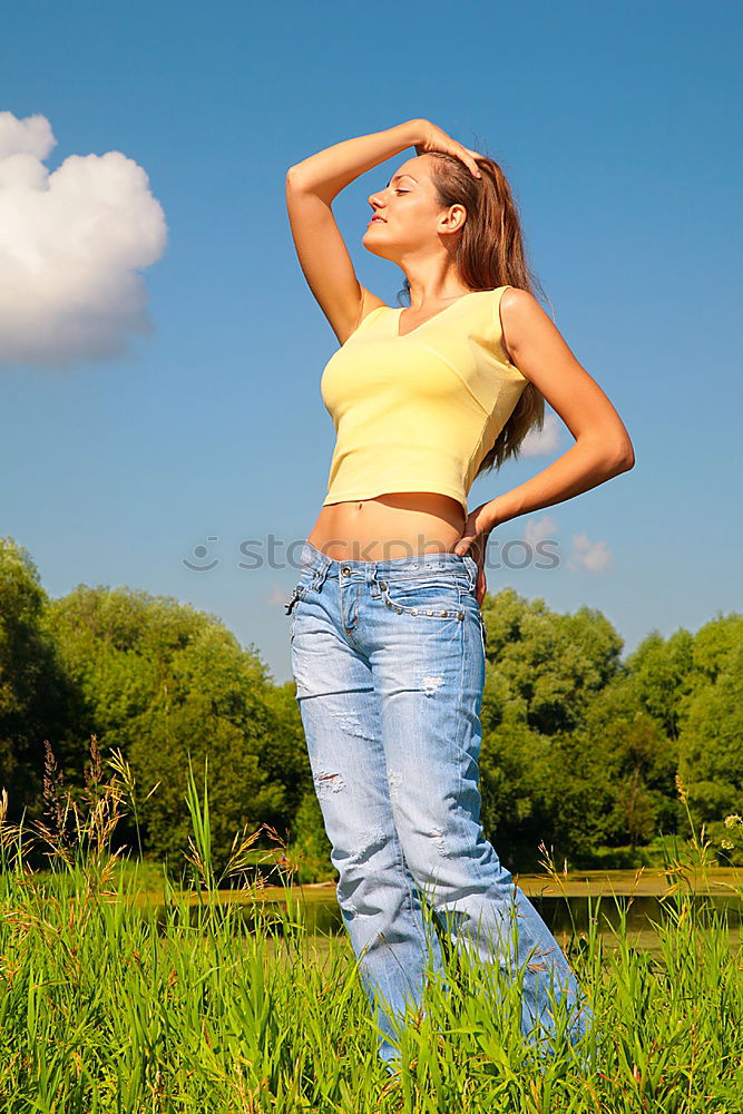 Similar – Women wearing t-shirt and jeans stays outdoor in the park