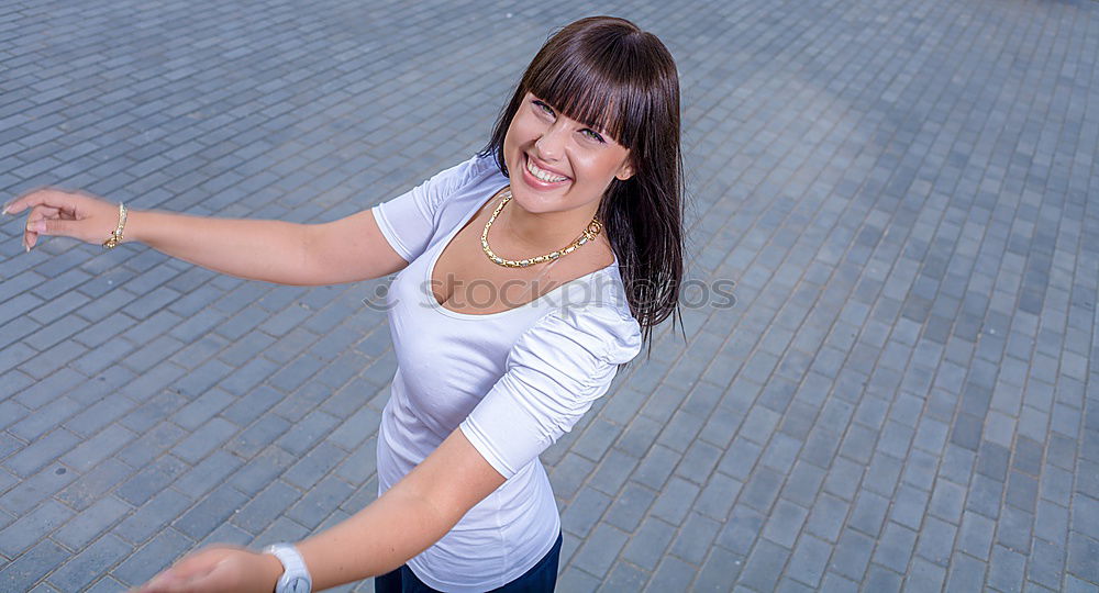 Similar – Happy female riding skate board in street