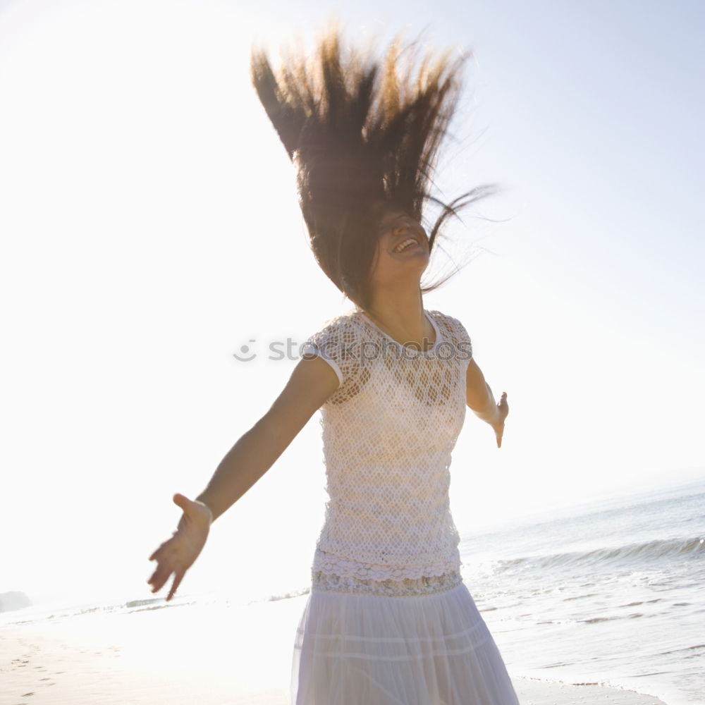 Blonde white woman moving the hair with the wind.