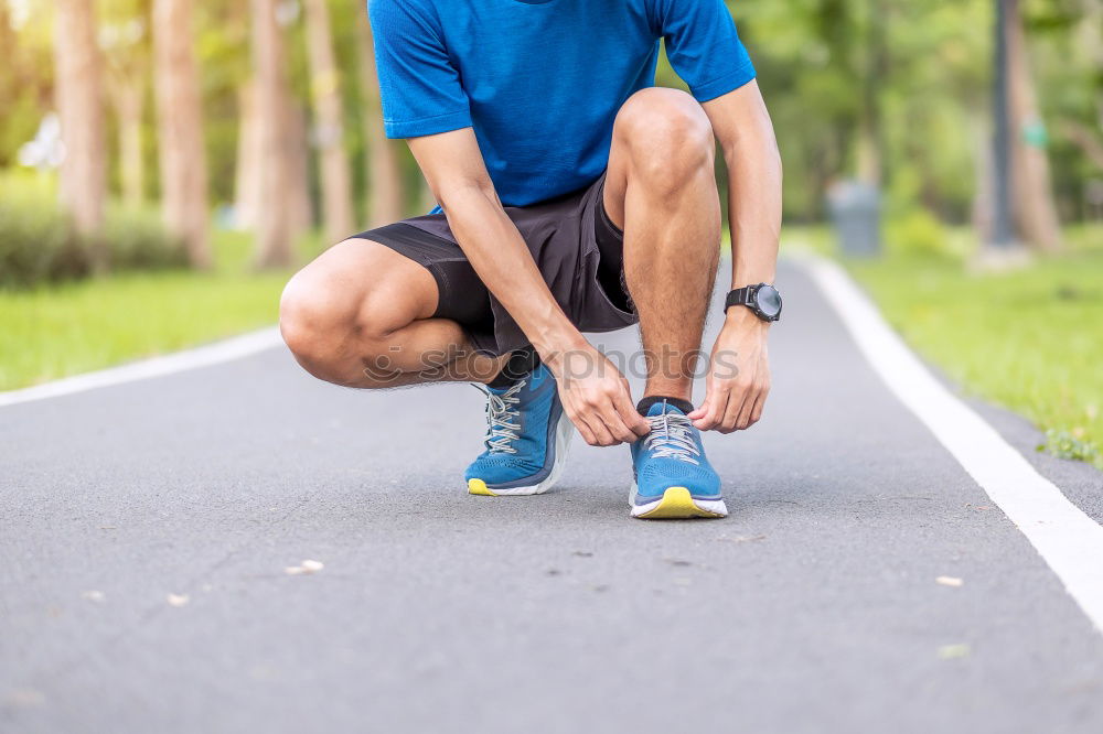 Similar – Runner get ready for run, tying sneakers shoelaces