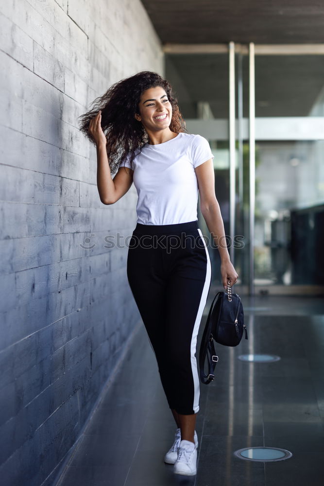Image, Stock Photo Happy Arab woman, black curly hairstyle sitting on urban floor.