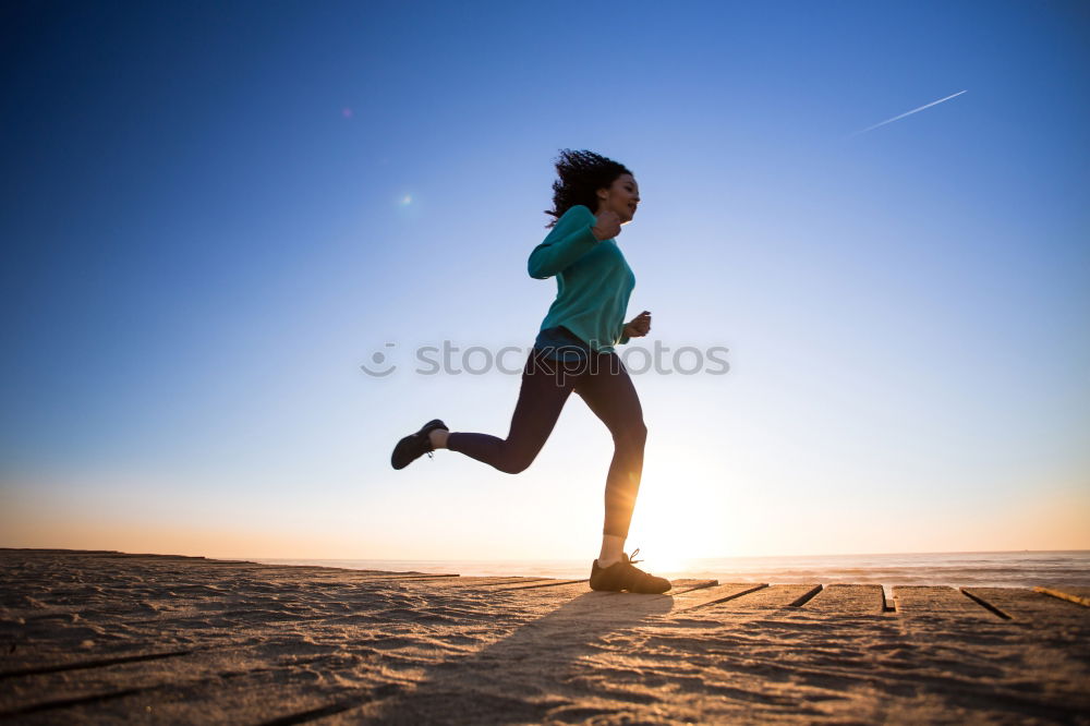 Similar – Man running at sunset on a sandy beach in a sunny day