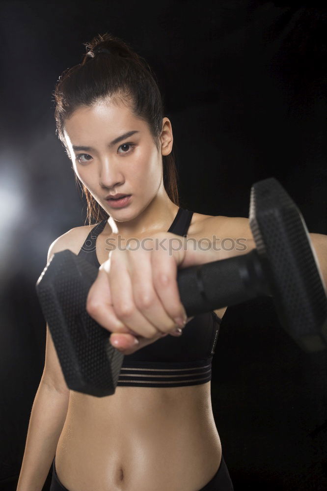 Similar – Image, Stock Photo Close up front portrait of one young athletic woman in sportswear in gym over dark background, standing in boxing stance with hands and fists, looking at camera