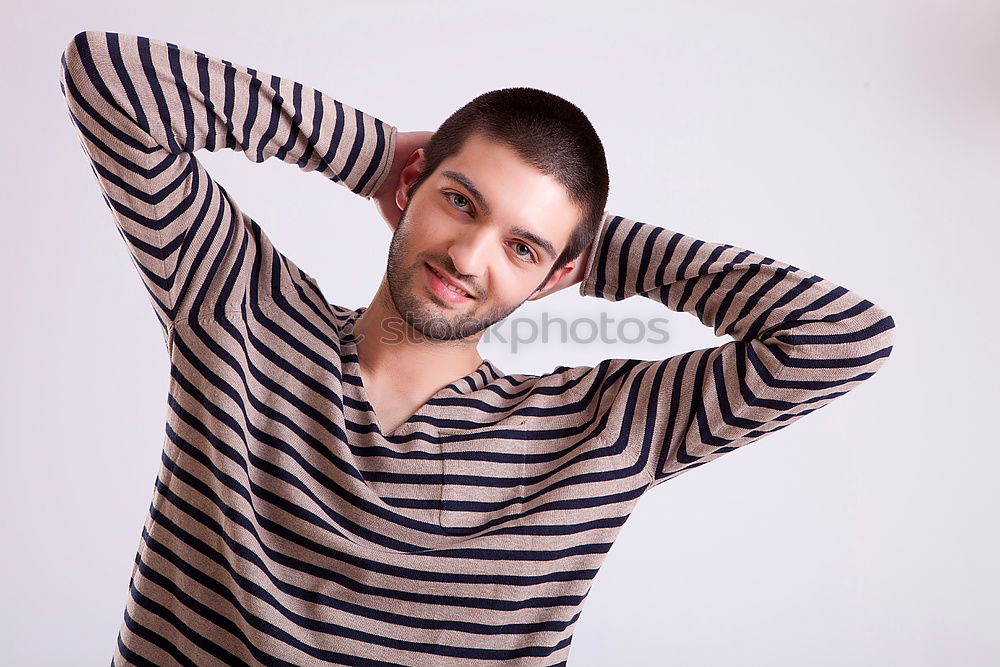 Similar – young handsome man with t-shirt against a wall in street